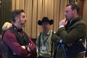 Stephane Beaudoin (left) speaks with audience members after his presentation at the 2019 Banff Pork Seminar.